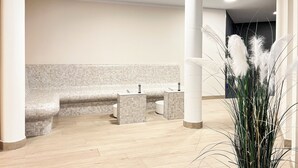 A modern bathroom with a bench, two sinks, and a decorative plant. - Baltischer Hof apartment 27 (Ostseebad Bolgenhagen)