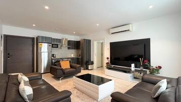 Deluxe Apartment, Balcony, Pool View | Living area | 52-inch Smart TV with satellite channels