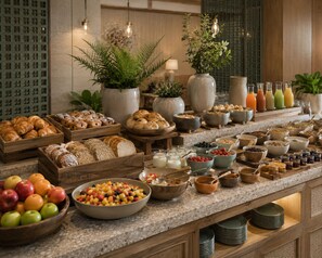 A buffet spread with various food items and beverages.