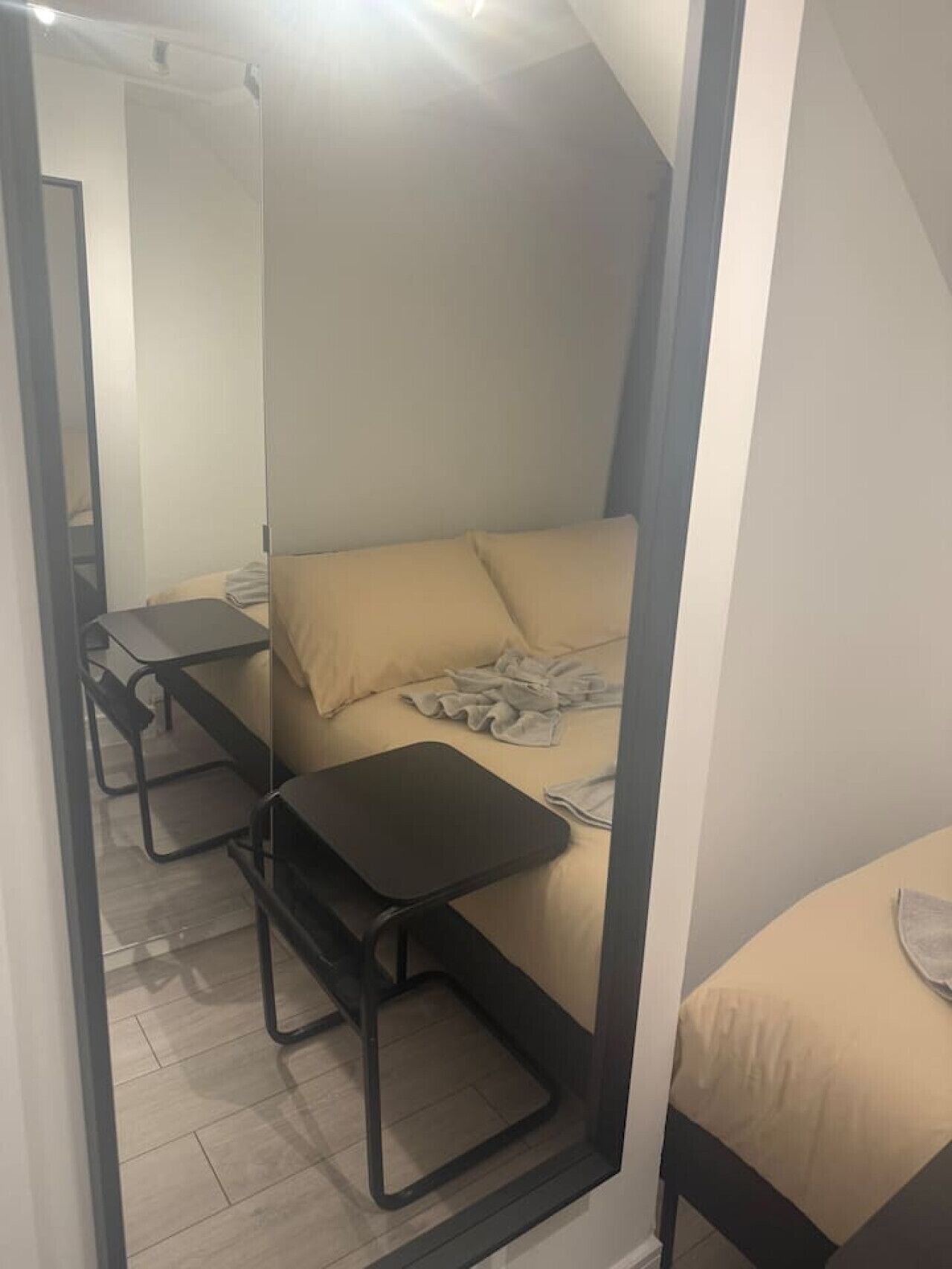 Una habitación pequeña con una cama, una mesita y una silla.