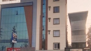 A hotel with a modern facade, including a prominent sign for 'Hotel Sriti Premium'.
