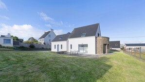 A residential house with a sloped roof, a stone foundation, and a grassy yard. - Magical Moments by the Sea (Camaret-sur-Mer)