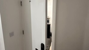 A white door with the number 2, a black handle, and a small electrical outlet on the wall. - London Borough 5 min walk (Greater London)