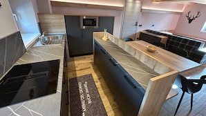 A modern kitchen with a built-in microwave, stainless steel sink, and a wooden countertop. - Apartment '1 Trilocale' with Mountain View, Balcony and Wi-Fi (Livigno)