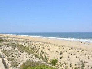 A beach with a sandy shore and a clear sky. - Oceanfront 3BR Condo w/ Views + Grill | Sleeps 8! (Fenwick Island)