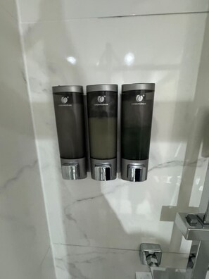 Three hand sanitizer dispensers mounted on a wall with a marble surface. - London Victoria 15 minutes away (Greater London)