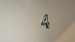 A plain wall with a metal fixture in the shape of the number 4. - London Waterloo Moments away (Greater London)