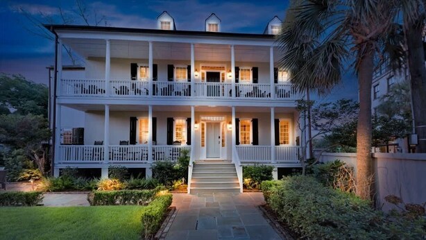 A two-story building with a central entrance, a covered porch, and a symmetrical facade. - Rare, Historical Estate near Market St w. Parking (Charleston)