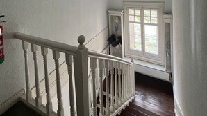 A staircase with white balusters leading to a landing.