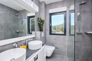 Appartement (4 Bedrooms) | Badkamer | Een douche, handdoeken, zeep, shampoo