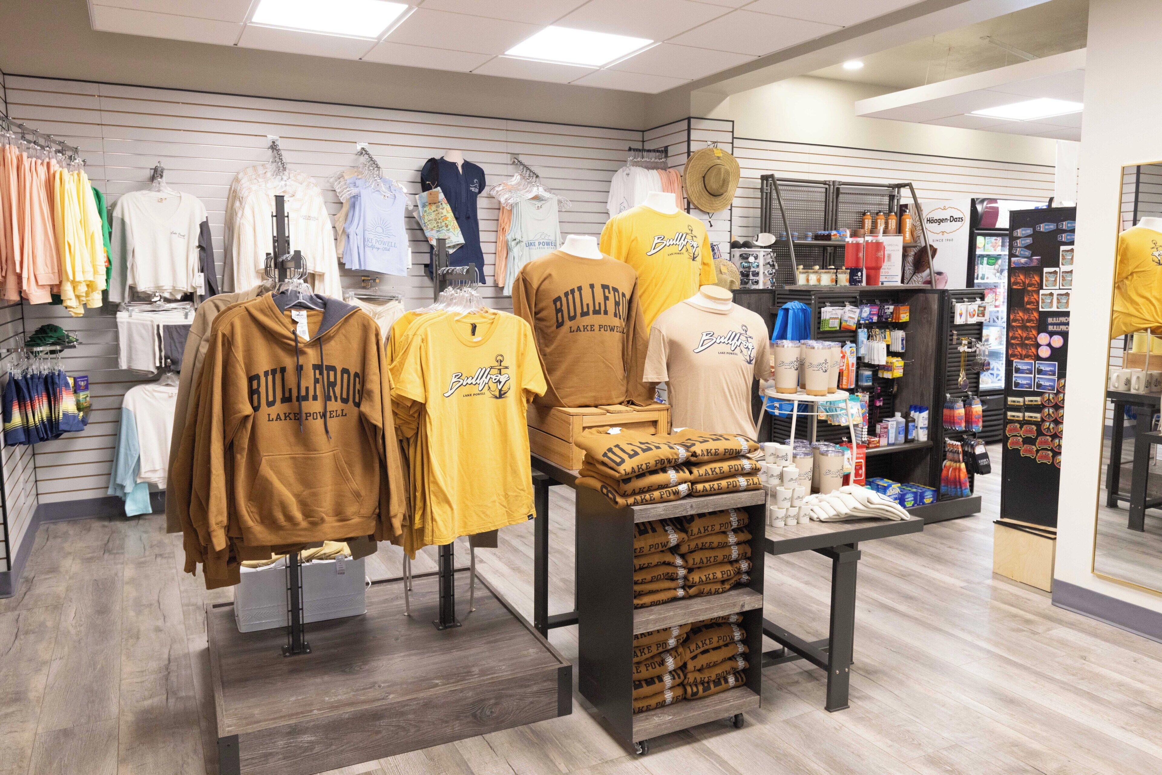 A clothing store with various apparel on display, including hoodies and t-shirts.