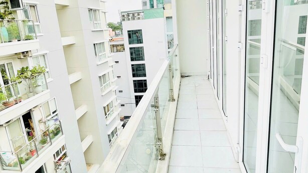 A modern apartment building with balconies, large windows, and a clear view of the surrounding area. - Stay Central-Prestige Address &Private Comfort. (Thành phố Hồ Chí Minh)