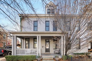 A two-story house with a porch, a mailbox, and a number 259 sign. - Step into the coziest two bedroom! (Columbus)