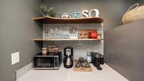A kitchen with a microwave, coffee maker, and tea set on the counter. - Blue Lotus Cottage, Walk to Downtown Kennett Square, Near Longwood Gardens (Kennett Square)