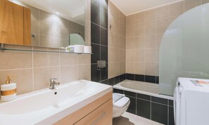 A modern bathroom with a large sink, a toilet, a bathtub, and a glass shower enclosure. - Rhodes Port Haven Suite (Rhodes)
