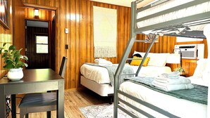 A compact room with a bunk bed, a desk, a chair, and a potted plant. - Smoky Mountain Creekside Retreat - Private Cabin with Backyard Stream (Maggie Valley)