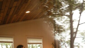 A bedroom with a bed, a large window, and a view of the outdoors. - Lux Cabin on Farm, River, Animals, Projector (Montgomery)