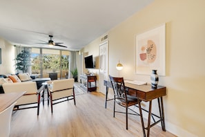 A modern living room with a sofa, chairs, a dining table, and a ceiling fan. - Stylish Old Town Scottsdale condo with pool, spa, gym, & game room (Scottsdale)