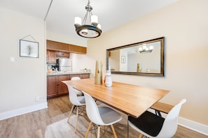 A modern kitchen with wooden cabinets, a stainless steel refrigerator, and a granite countertop. - Stylish Old Town Scottsdale condo with pool, spa, gym, & game room (Scottsdale)