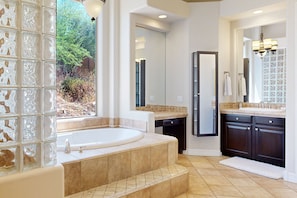 A modern bathroom with a large bathtub, a walk-in shower, and a vanity with a mirror. - Beautiful mountain-view home with fireplace, private pool, grill, patio & W/D (Cave Creek)