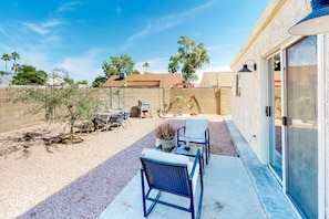 A patio with outdoor furniture, a small table, and a potted plant. - Charming home near walking paths with a work desk, grill, & patio - dog-friendly (Tempe)