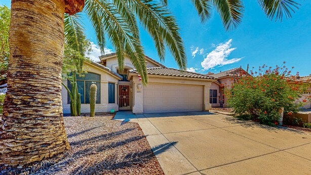 A residential house with a garage, palm trees, and a clear blue sky. - Updated home with private pool, enclosed yard, covered patio, grill, & W/D (Glendale)