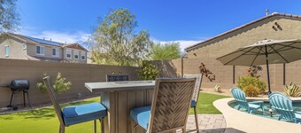 Airy desert home with an enclosed yard, private pool, hot tub, firepit, & W/D