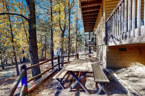 Outdoor dining - Serene, two-story cabin with a game room, washer/dryer, & furnished deck (Lakeside)