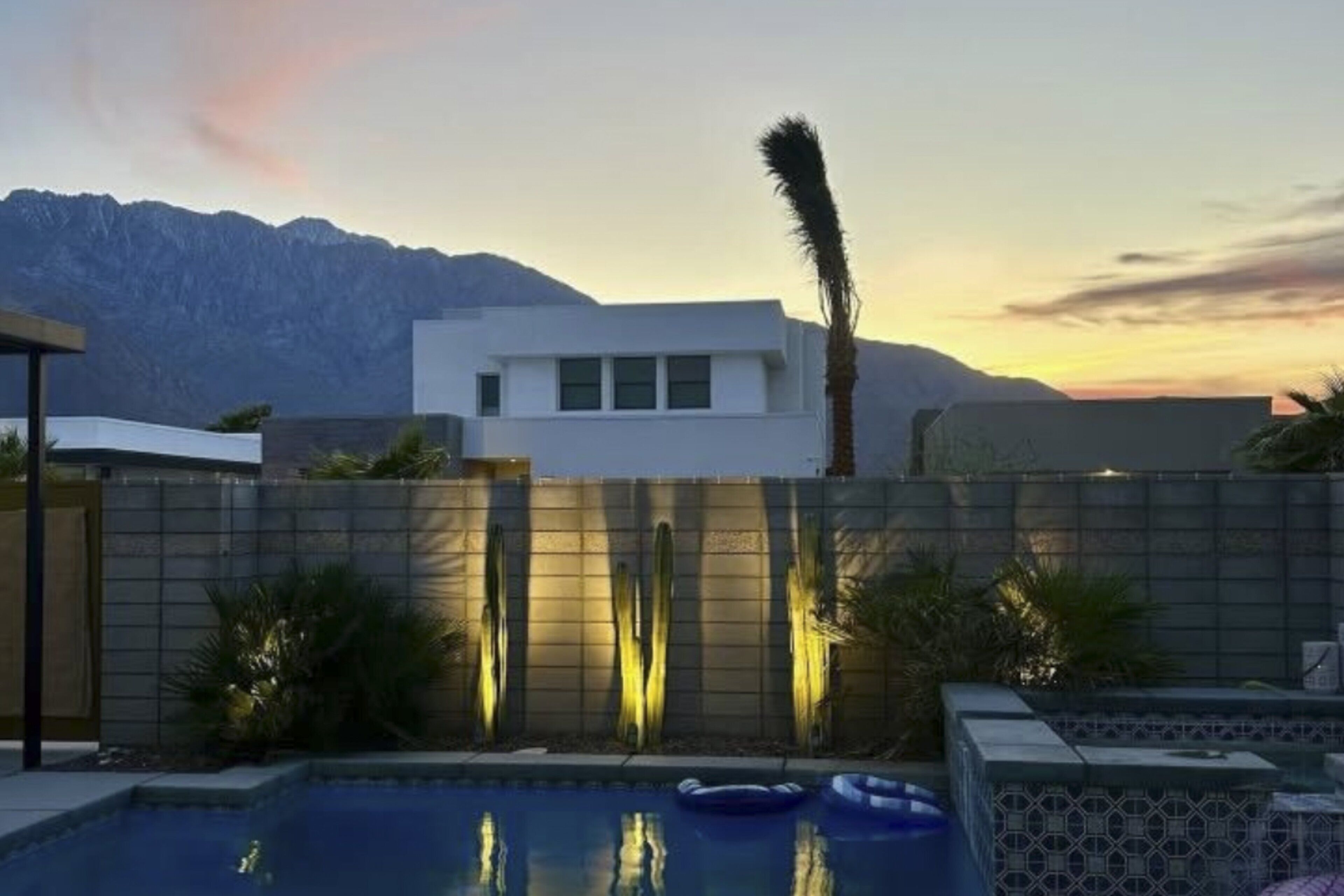 A modern pool area with a clear view of mountains in the background.