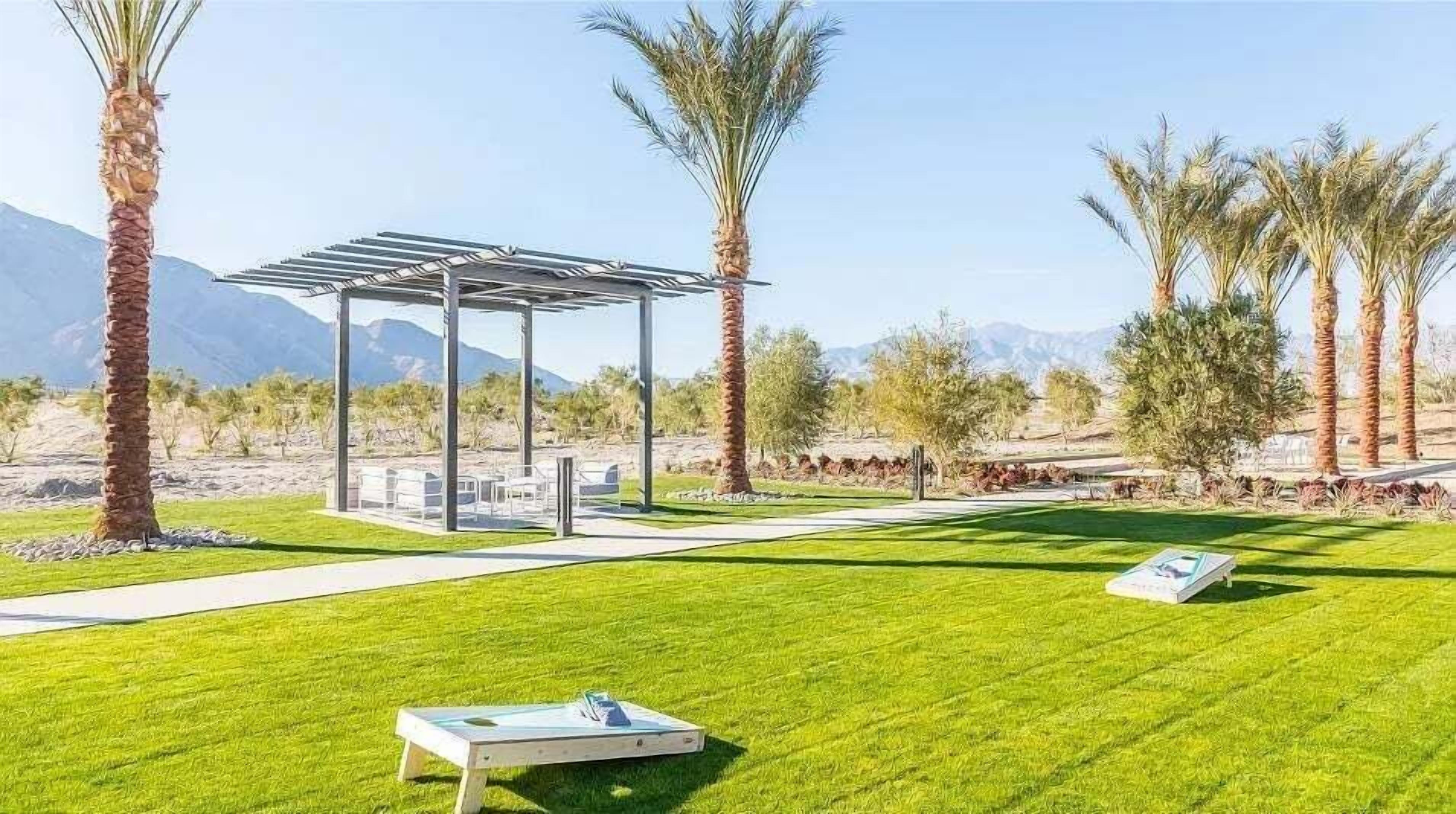 A well-maintained outdoor area with a pergola, seating, and a pool table.