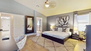 A bedroom with a bed, bedside tables, a desk, a chair, and a ceiling fan. - Pristine Desert Ridge home with a pool & backyard oasis - dog-friendly (Phoenix)