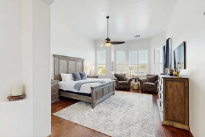 A bedroom with a bed, nightstands, a dresser, a chair, and a ceiling fan. - Dog-Friendly Desert Oasis w/ a Gourmet Kitchen, Private Pool, & Putting Green (Marana)
