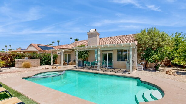 A swimming pool with a pergola, outdoor seating, and a view of a residential building. - Chic Cathedral City Home with Private Pool & Spa | Minutes to Palm Springs (Cathedral City)