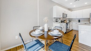 A modern kitchen with white cabinets, a microwave, and a coffee maker. - Charming Condo with Central A/C & Washer/Dryer - Shared Pool & Hot Tub (Phoenix)