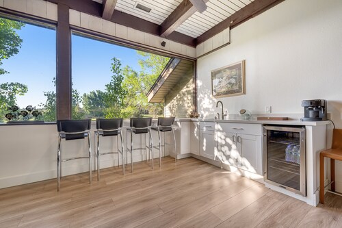 Refined home with a game room, balcony, grill, washer/dryer, & four bedrooms