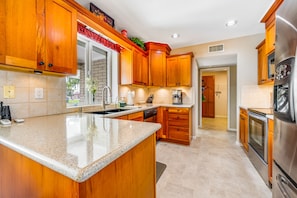 Fridge, microwave, oven, stovetop - Dog-friendly, golf course adjacent home with a pool, hot tub, & fitness center (Mesa)