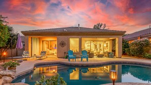 A modern house with a swimming pool, outdoor seating, and a well-lit patio area. - Snowbird-Friendly Home with Private Pool, Grill, AC, Fireplace, & WiFi - Dogs OK (Glendale)