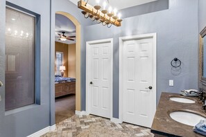 A bathroom with two sinks, a shower, and a vanity. - Snowbird-Friendly Home with Private Pool, Grill, AC, Fireplace, & WiFi - Dogs OK (Glendale)