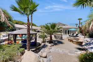A resort with a gazebo, outdoor seating, palm trees, and a pool area. - Palm Desert's Ultimate Group Retreat — Space, Amenities & a Backyard That Steals the Show (Palm Desert)