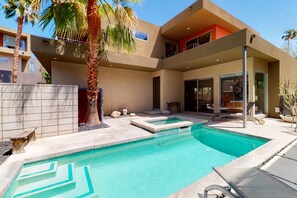 A modern pool area with two pools, a covered seating area, and a building with balconies. - Family-Friendly Condo w/ Mountain Views, Private Pool (Palm Springs)