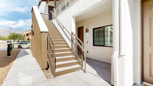 A multi-story building with a staircase leading to the entrance.