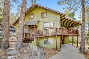 A two-story house with a balcony, surrounded by trees. - Dog-Friendly Getaway with Fast WiFi, Wood-Burning Fireplace, & Furnished Deck (Idyllwild)