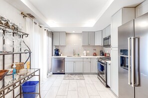 A modern kitchen with stainless steel appliances, a dishwasher, and a built-in oven. - Dreamy Desert Hideaway | Pool, Hot Tub & 2 Patios - Near Dining, Shops & Golf (Palm Desert)