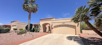 Mountain-view home with shaded patio, large yard, on-site golf & tennis