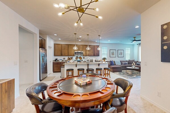 A modern kitchen with a central island, stainless steel appliances, and pendant lighting.