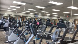A gym with multiple treadmills and exercise equipment. - Modern 55+ home with community pool, clubhouse, gym, pickleball (Goodyear)
