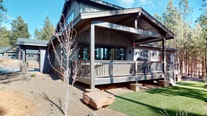 A modern two-story house with a covered porch and a stone foundation. - Updated luxury home with ensuite bedrooms, fireplace, & large deck w/ firepit (Flagstaff)