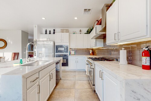 Spacious escape with enclosed yard, outdoor living, pool table, & fireplace