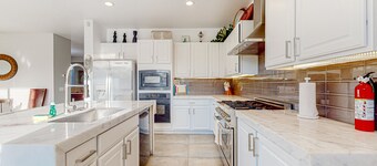 Spacious escape with enclosed yard, outdoor living, pool table, & fireplace