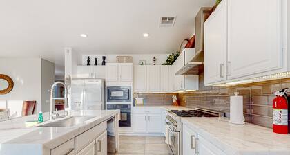 Spacious escape with enclosed yard, outdoor living, pool table, & fireplace